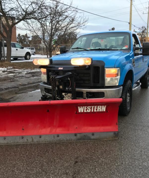 Snow Removing Car on Road.
